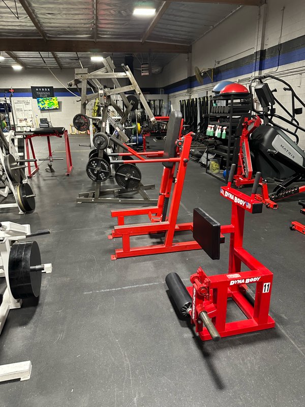 A line of red strength machines along the lifting floor.