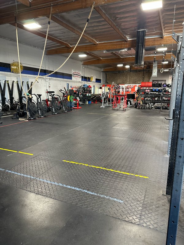 The open turf lane and conditioning area under the warehouse lights.