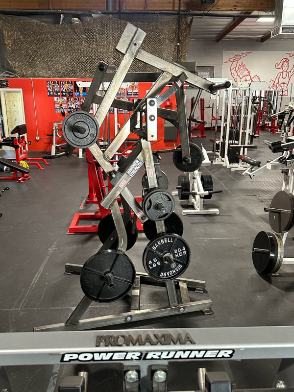 A plate-loaded lever machine loaded with iron plates.