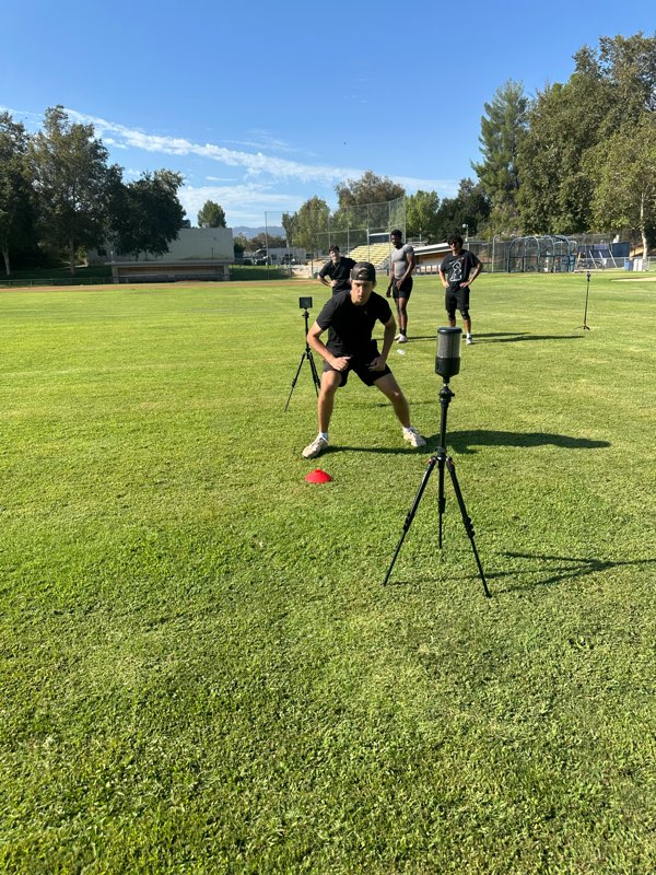 An athlete running an agility drill through timing gates.