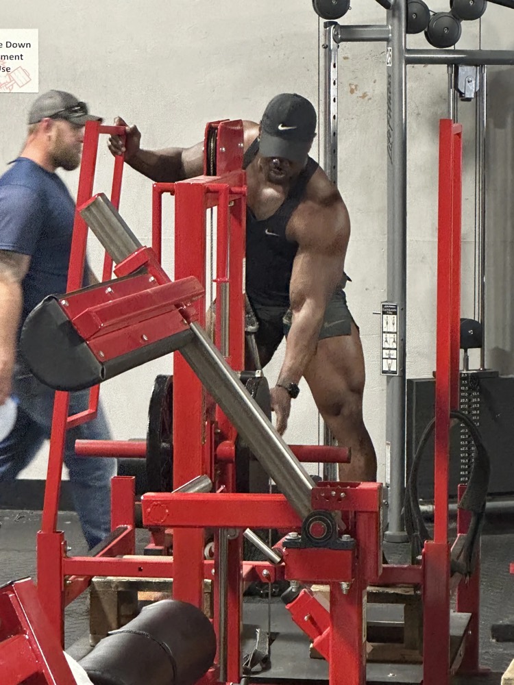 A member training on a plate-loaded machine.