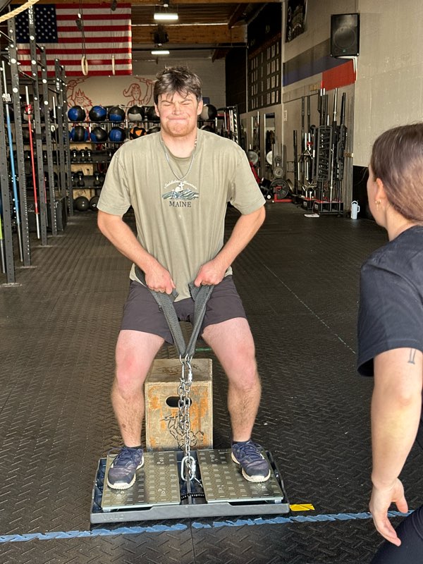 An athlete doing an isometric mid-thigh pull on the force plates.